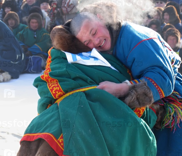 NADYM, RUSSIA - March 17, 2006: National Holiday - Day of the reindeer herders. The wrestling unknown men on holiday in Nadym, Russia - March 17, 2006.