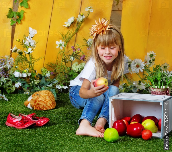 Girl 6 years old in garden with apples
