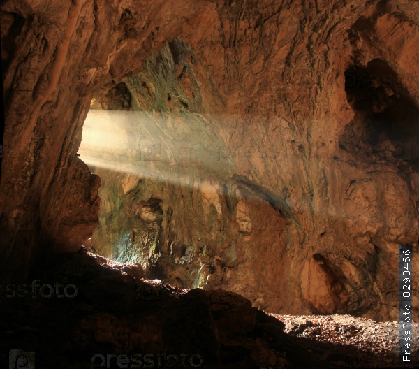 big cave with bright sunbeam from entrance