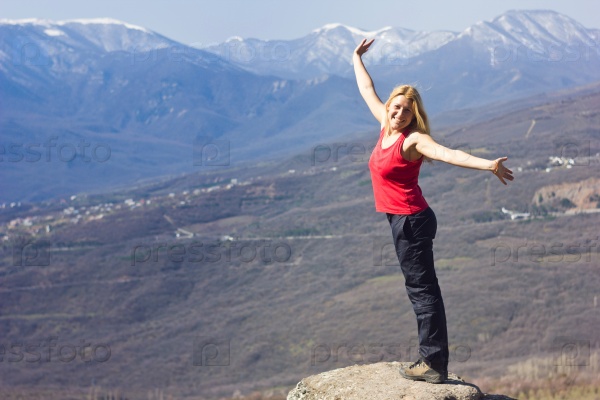 freedom girl standing on a cliff and thinking in the mountains