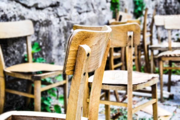 Vintage old school chairs rotting in a backyard, shallow depth of field, stock photo