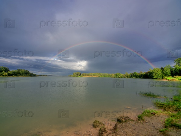 Summer landscape with two rainbows over lake. Ruzskoe lake in Russia