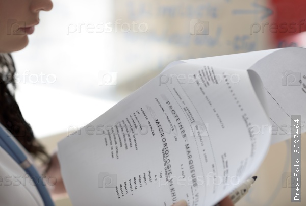 Closeup of female doctor hands holding test results of her patient
