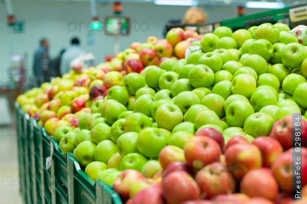 Bunch of red and green  apples on boxes in supermarket