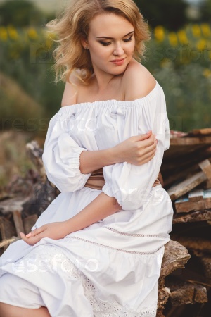 portrait of blond woman in white dress outdoor. closeup of beautiful girl in long white dress outdoors.blonde beautiful woman