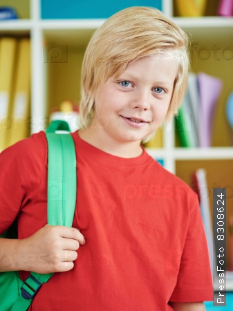 Happy pupil with backpack looking at camera