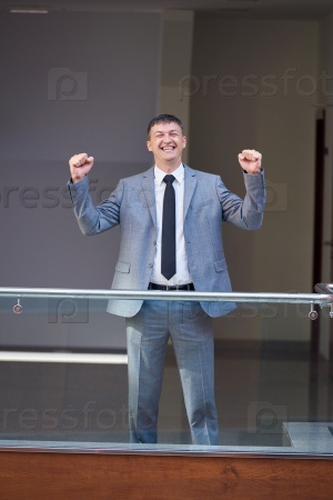 happy business man raise hands from joy