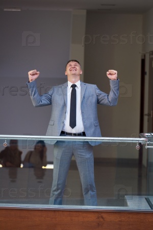 happy business man raise hands from joy
