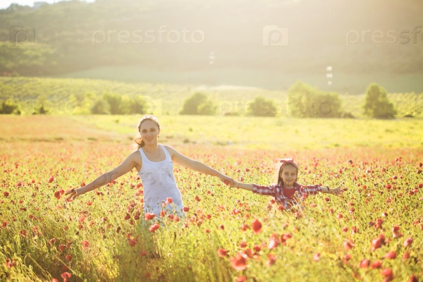 Mom and her 6 years old child playing in spring flower field