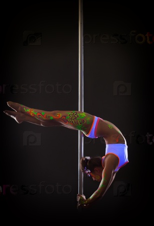Beautiful pole dancer posing with neon makeup