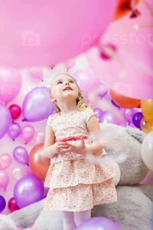 Lovely girl playing in game room of balloons