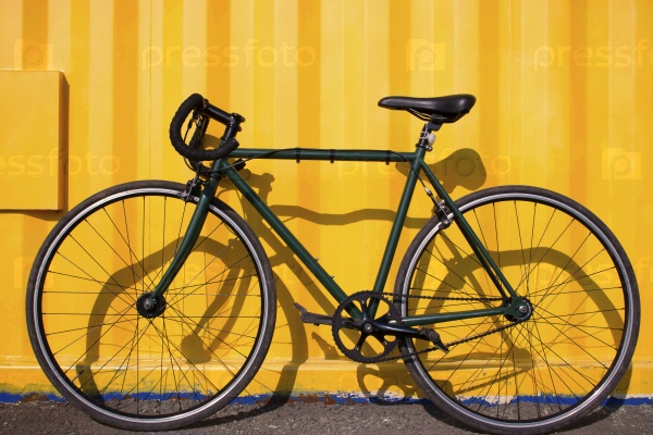 city bike fixed gear on a yellow background selective focus