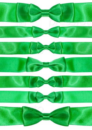 set of symmetric bow knots on green satin ribbons isolated on white background