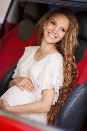 Pregnant beautiful young woman with car outdoor. Pregnant smiling pretty woman in standing near car. pregnancy and car. Pregnant brunette girl with big belly