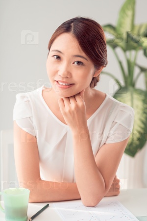 Pretty Japanese business lady working with financial report
