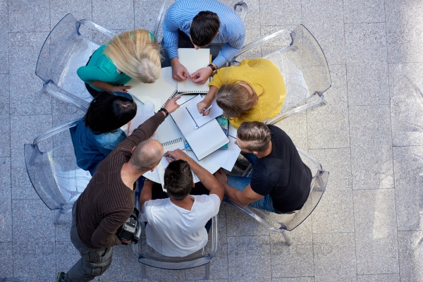 top view,  group of students together  at school table working homework and have fun