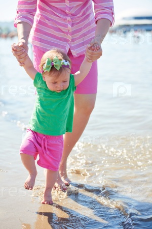 mom and baby on beach have fun