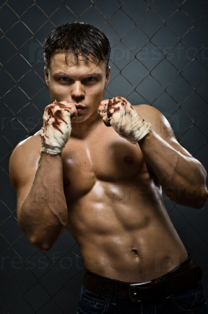 vertical photo  muscular young  guy street-fighter,  aggression look, hard light