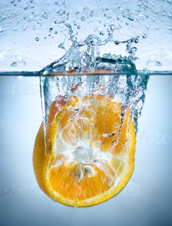 one yellow orange drop in blue water with splashes