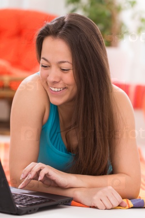 Young beautiful asian woman with notebook at home