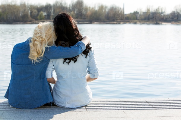 Friendship. Best friends sitting by the river