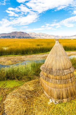 Floating  Islands on Lake Titicaca Puno, Peru, South America,thatched home. Dense root that plants interweave form natural layer called Khili about one to two meters thick that support islands