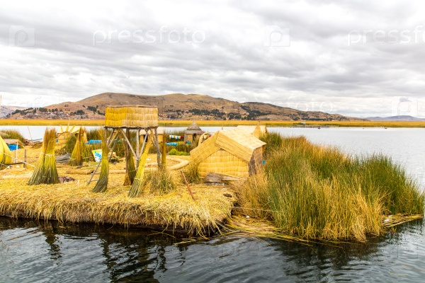 Floating Islands on Lake Titicaca Puno, Peru, South America, thatched home. Dense root that plants Khili interweave form natural layer about one to two meters thick that support islands