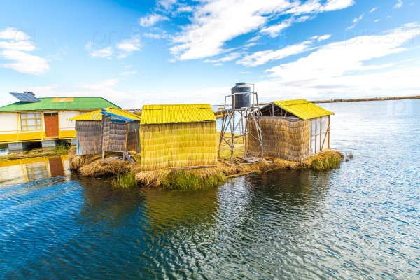 Floating  Islands on Lake Titicaca Puno, Peru, South America, thatched home. Dense root that plants Khili interweave form natural layer about one to two meters thick that support islands