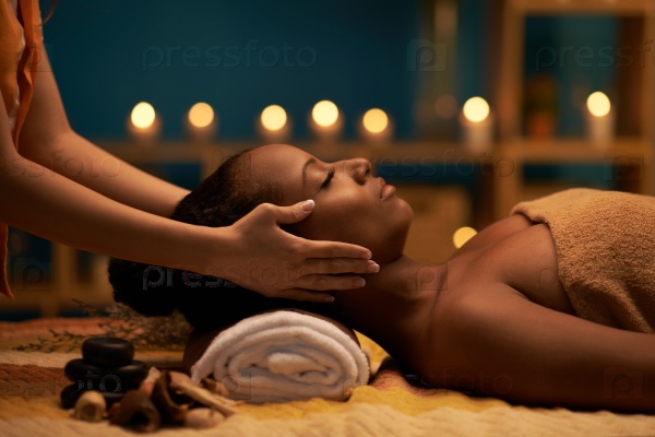 Female therapist doing professional rejuvenating face massage