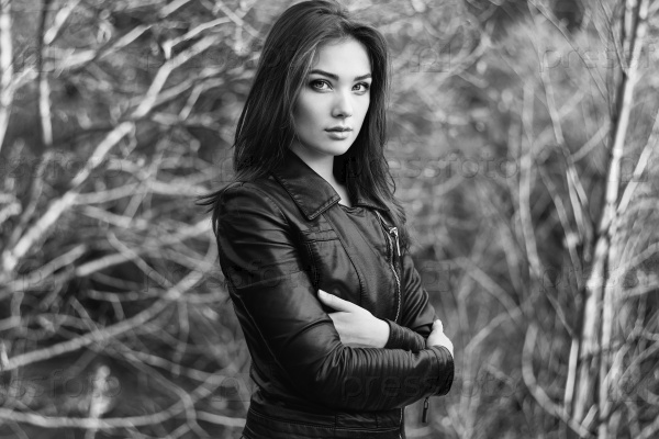Portrait of young beautiful woman in leather jacket