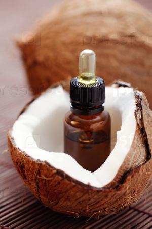 bottle of coconut essential oil - beauty treatment