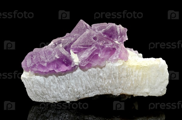 Sample of a beautiful Pink Fluorite nature specimen isolated on black background, stock photo