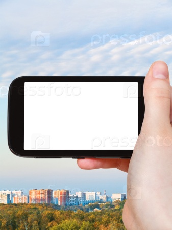 smartphone with cut out screen and city in autumn