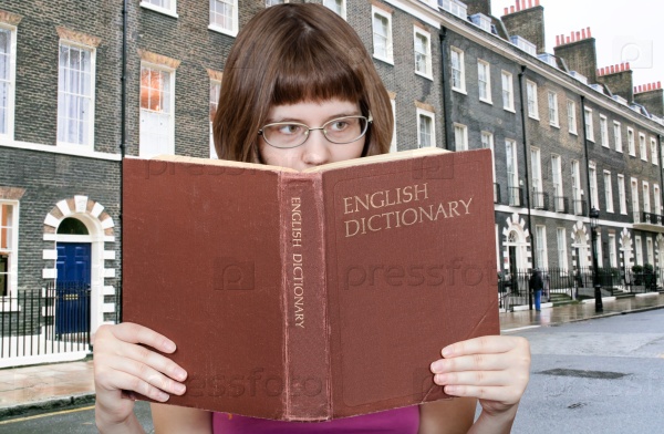 girl reads over English Dictionary and house