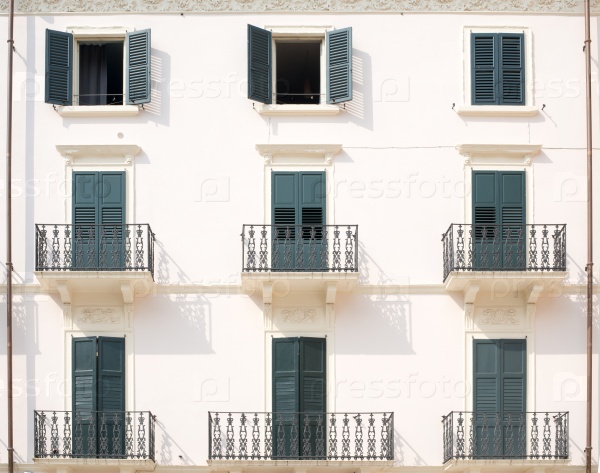 House with balconies and balcony railings with doors, stock photo