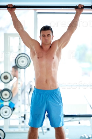 handsome young mand working out in gym