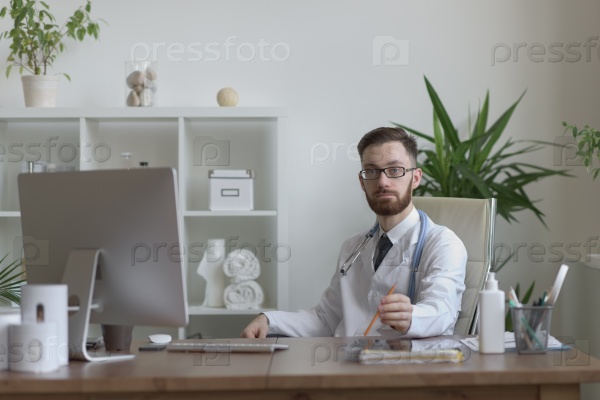Doctor sitting relaxed in his chair in the office