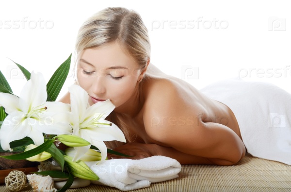 Spa Woman with flowers of lily isolated on white