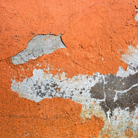 Orange painted grunge concrete wall. Abstract background.