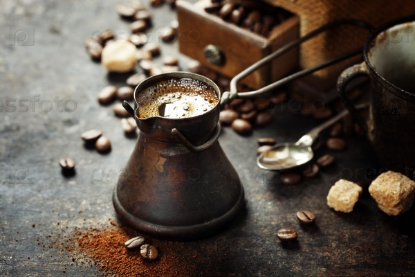 Old coffee pot and mill on dark rustic  background