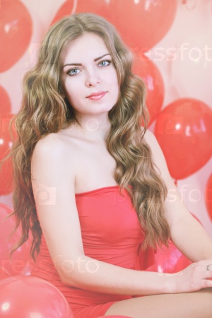 Beautiful long-haired woman with big red balloons