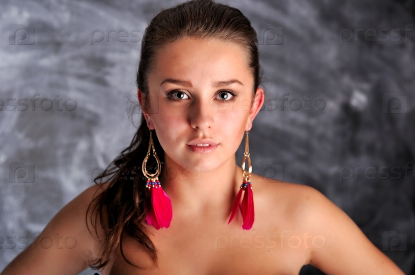 Young woman portrait with long red earrings