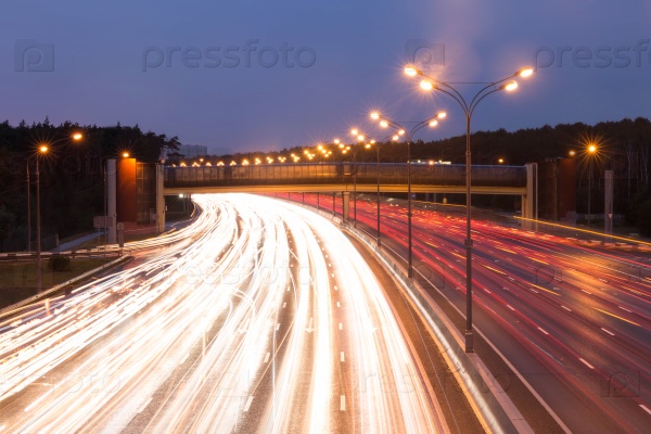 Illuminated highway at evening with light trails, stock photo