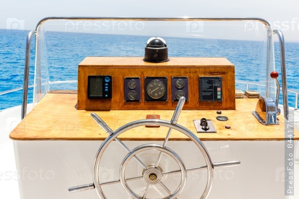 Sailing yacht control wheel and navigation implement.