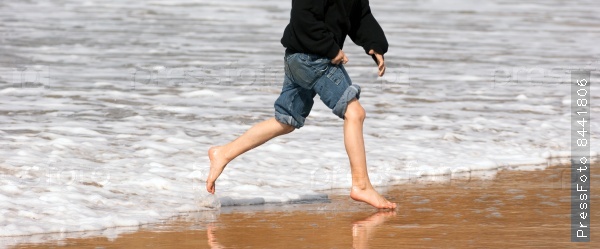Young Boy Running Feet Ocean Beach Surf Crashing Sea Foam