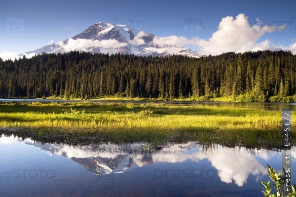 The mountains reflection is shown in Reflection Lake inside the park