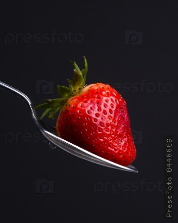 A Silver Spoon Silverware Utensil Holds Fresh Raw Food Red Strawberry Sweet Snack
