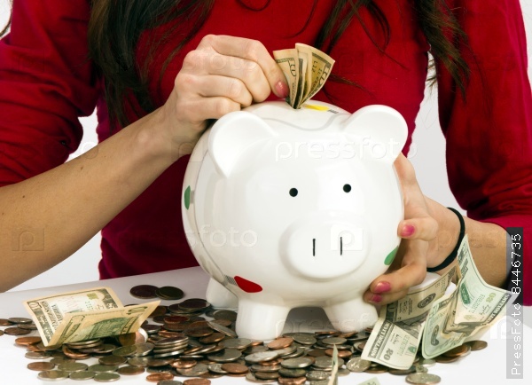Woman Stuffing US Currency Coins Piggy Bank Cash Savings