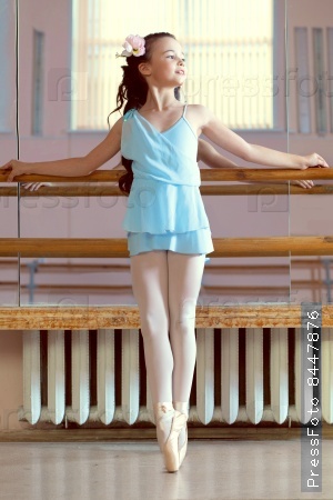 Image of lovely young ballerina posing in dance class