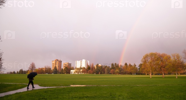 Rainbow Appears Over Park During Thunderstorm Pedestrian